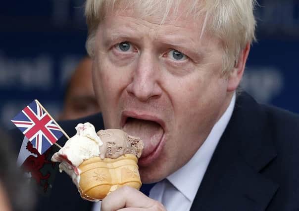 Prime Minister Boris Johnson eats an ice cream adorned with a Union Jack during a visit to Barry Island, South Wales (Picture: Frank Augstein/PA Wire)