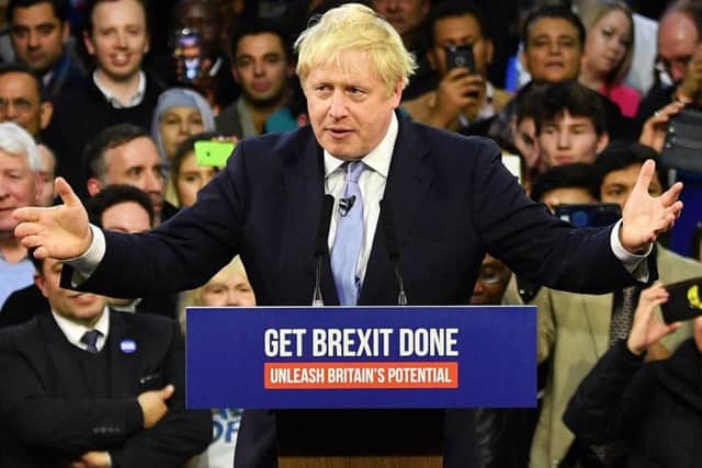 Boris Johnson on a podium with his campaign slogan of 'Get Brexit Done'. Picture: PA