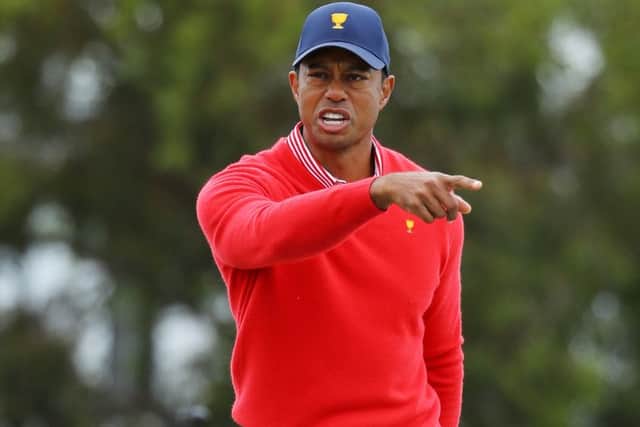 Did you see that? - seems to be the message as Tiger Woods points to the fifth hole having chipped in from off the green. Picture: Getty.