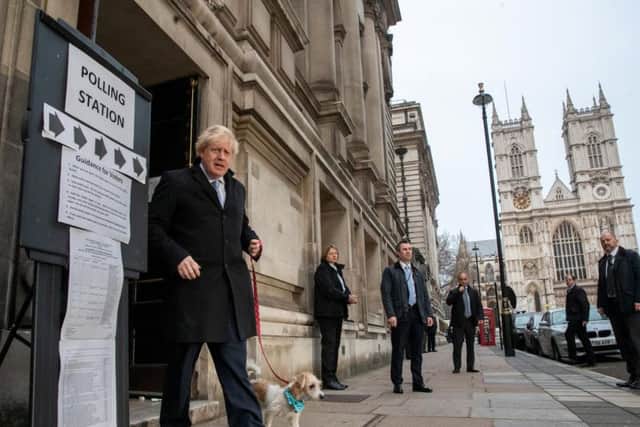 Boris Johnson leaves the Westminster polling station with dog Dilyn after voting in the general election
