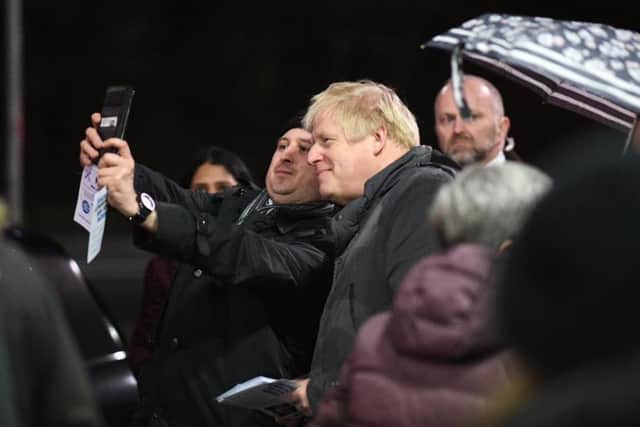 Boris Johnson gets a selfie with a constituent while campaigning in his own seat on election night