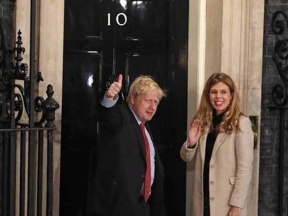 Prime Minister Boris Johnson and his girlfriend Carrie Symonds arrive in Downing Street after the Conservative Party was returned to power