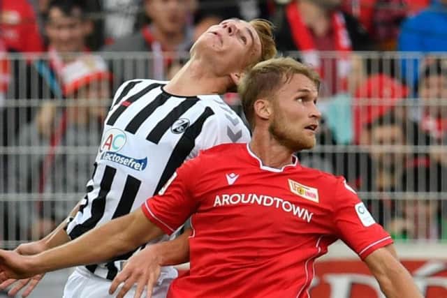 Andersson battles for the ball with Freiburg defender Philipp Lienhart
