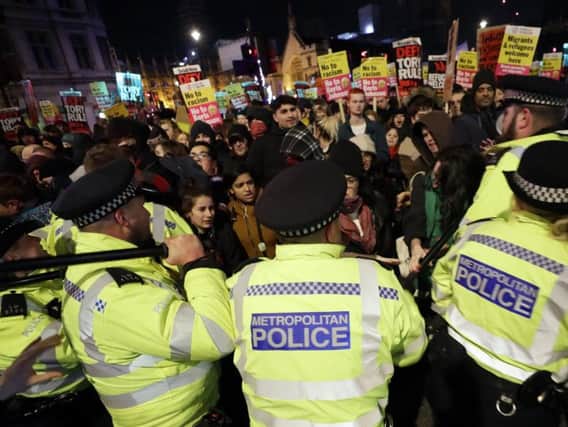 People scuffle with police during an anti-Boris Johnson demonstration.