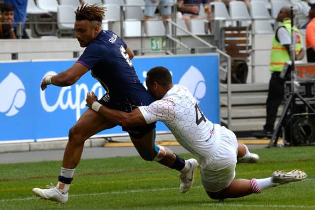 Scotland's Femi Sofolarin escapes the clutches of England's Dan Norton to score the winning try in their Pool C clash at the Cape Town Sevens. Picture: AFP via Getty Images