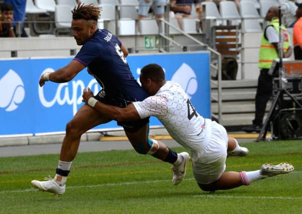 Scotland's Femi Sofolarin escapes the clutches of England's Dan Norton to score the winning try in their Pool C clash at the Cape Town Sevens. Picture: AFP via Getty Images