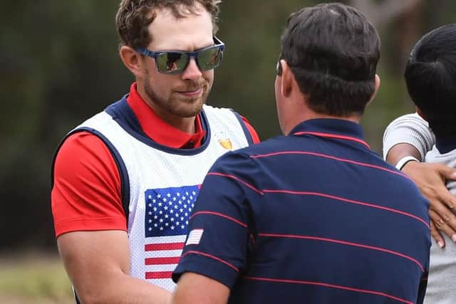US caddie Kessler Karain shakes hands with his player Patrick Reed. Picture: Getty Images