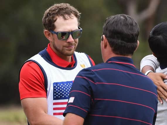 US caddie Kessler Karain shakes hands with his player Patrick Reed. Picture: Getty Images