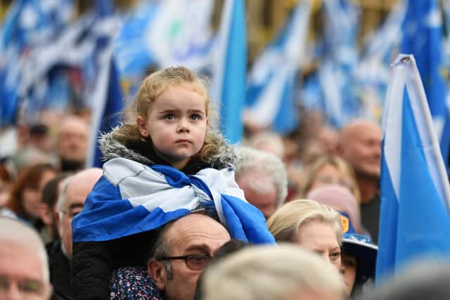 A child watches on at last month's Scottish independence rally in Glasgow's George Square
