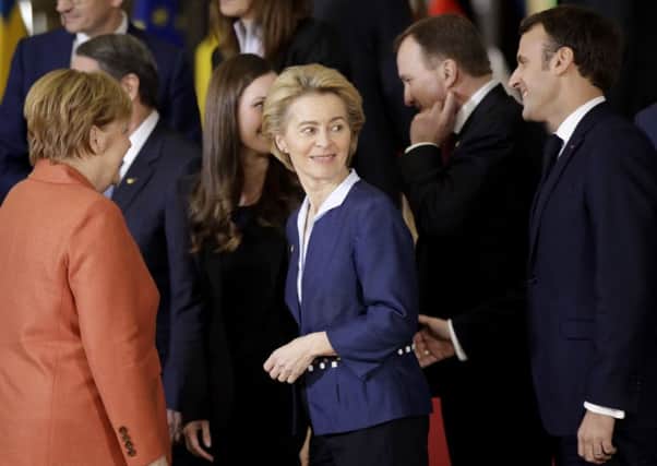 New European Commission president, Ursula von der Leyen, with German Chancellor Angela Merkel and French President Emmanuel Macron, spoke strongly about the need to act on climate change (Picture: Olivier Matthys/AP)