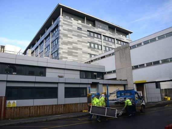 Health board bosses have recommended starting court proceedings against construction firm Brookfield Multiplex amid infection concerns and in the wake of children dying in the hospital.