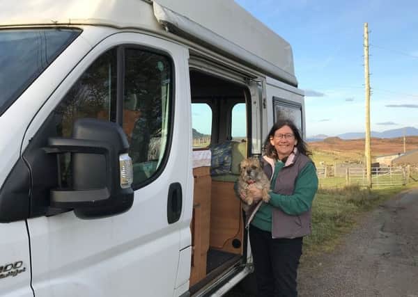 Rev Fiona Ogg, whose church in Kilchoan closed in 2018, at the door of her second-hand Fiat Ducato with her dog.