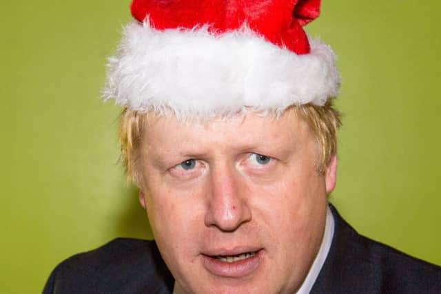 Boris Johnson plays Santa.  Photo by Tom Nicholson/Shutterstock