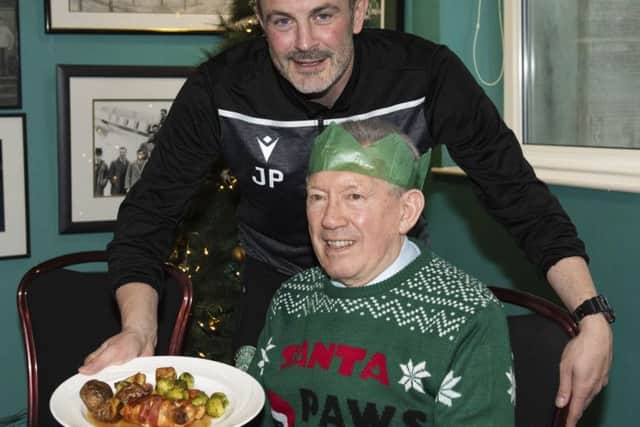 Hibs assistant boss John Potter serves Christmas dinner at the SPFL Trust's Festive Friends event at Easter Road. Picture: Craig Foy/SNS