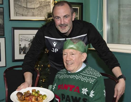 Hibs assistant boss John Potter serves Christmas dinner at the SPFL Trust's Festive Friends event at Easter Road. Picture: Craig Foy/SNS
