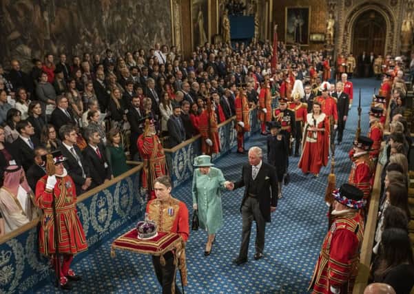 Queen Elizabeth II and Prince Charles, Prince of Wales proceed through the Royal Gallery on their way to the Lord's Chamber to attend the State Opening of Parliament. Picture: Jack Hill - WPA Pool/Getty Images