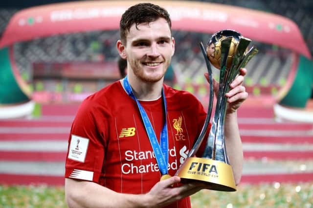 Liverpool full-back Andy Robertson lifts the Club World Cup trophy in Doha. Picture: Adam Davy/PA