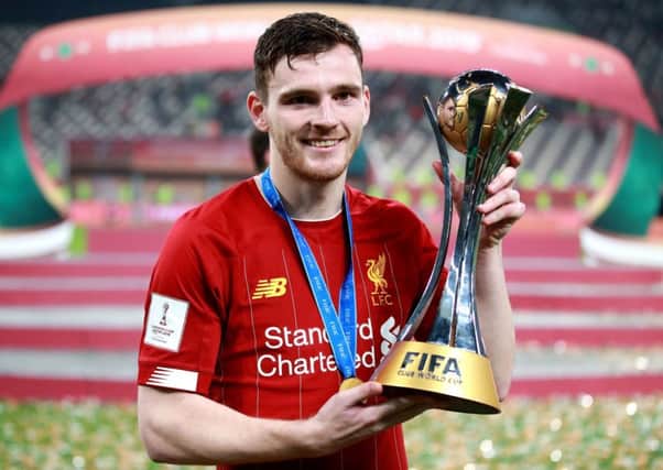 Liverpool full-back Andy Robertson lifts the Club World Cup trophy in Doha. Picture: Adam Davy/PA