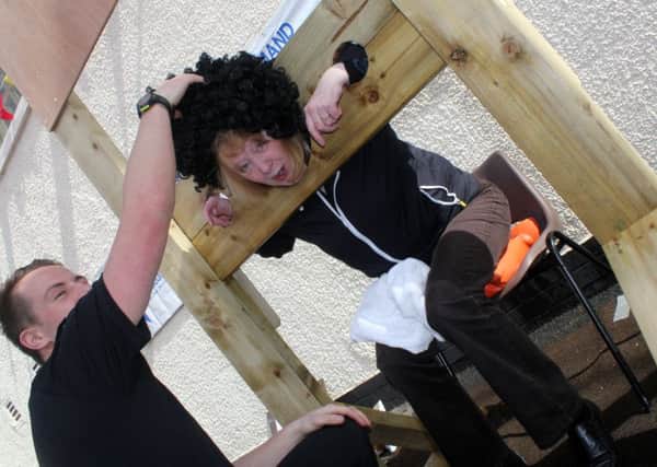 This modern recreation of the stocks was just for fun, but in medieval times, it was a means to publicly shame offenders