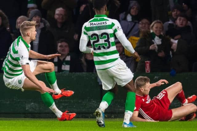Kristoffer Ajer, left, goes to ground after a tackle by Aberdeen defender Sam Cosgrove. Picture: SNS