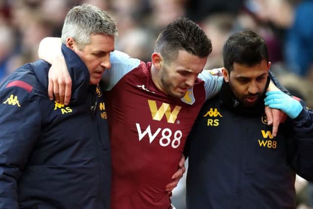 John McGinn is helped off the pitch. Picture: Nick Potts/PA Wire