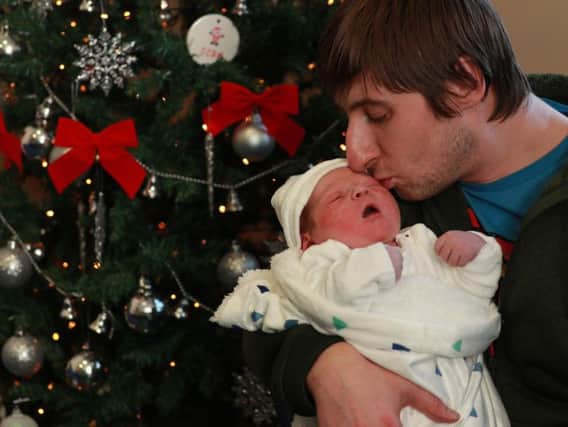 Proud father Zbigniew Kazimerczuk with his son Oliver, who was born in Edinburgh in the early hours of Christmas Day. PIC: PA.