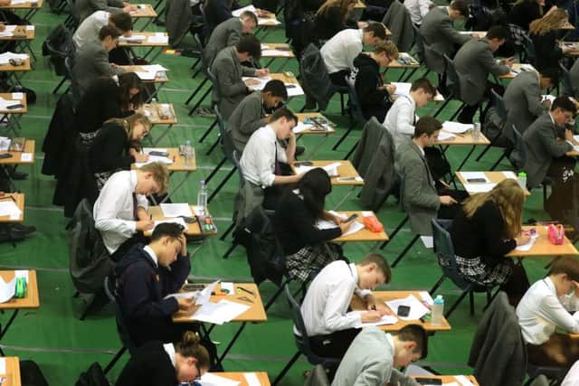 It is claimed the number of exams pupils sit is down to a postcode lottery. Picture: PA