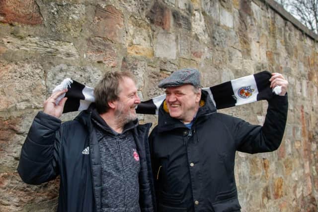 Ronnie Wilkes (wearing flat cap) and his friend and commentator Ian Boardman, who attend junior football matches together. Picture: Scott Louden