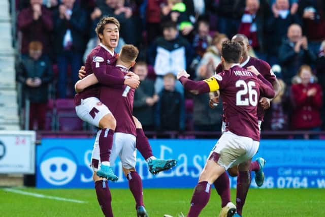 Ryotaro Meshino is congratulated after scoring the opener