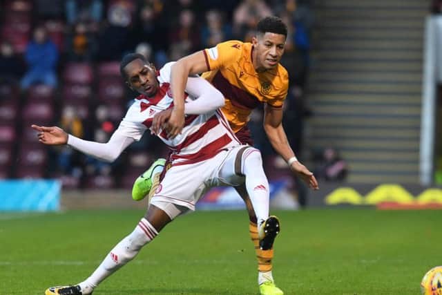 Mikel Miller and Jake Carroll battle for the ball