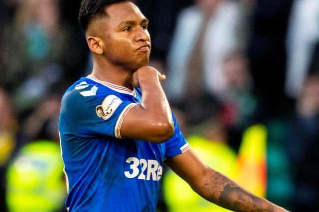 Alfredo Morelos drags his finger across his throat as he leaves the field of play following his red card