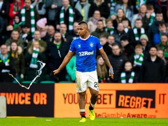 Alfredo Morelos makes his way from the pitch after being sent off against Celtic