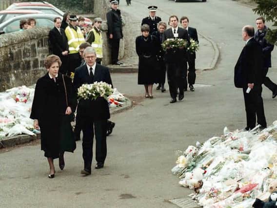 Then Prime Minister John Major and his wife, Norma, along with Labour's then leader Tony Blair, bring floral tributes to the gates of the school on March 15th, 1996.