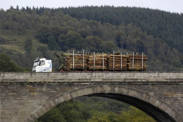 A timber lorry travels over the bridge over the Tay at Dunkeld, Perthshire. tourism. for special reports. forestry. wood.