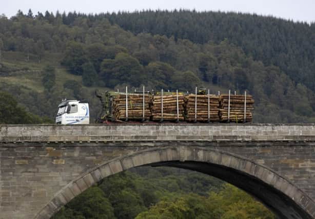 A timber lorry travels over the bridge over the Tay at Dunkeld, Perthshire. tourism. for special reports. forestry. wood.