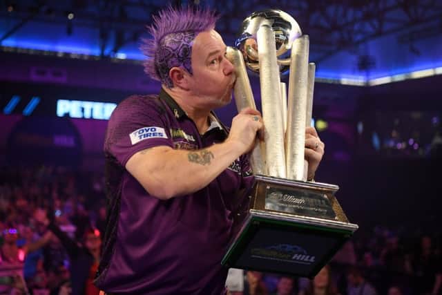 Peter Wright seals it with a kiss after winning his first PDC World Championship title on an emotional night for the Scot at Alexandra Palace. Picture: Getty.