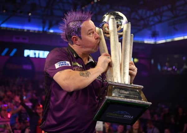 Peter Wright seals it with a kiss after winning his first PDC World Championship title on an emotional night for the Scot at Alexandra Palace. Picture: Getty.