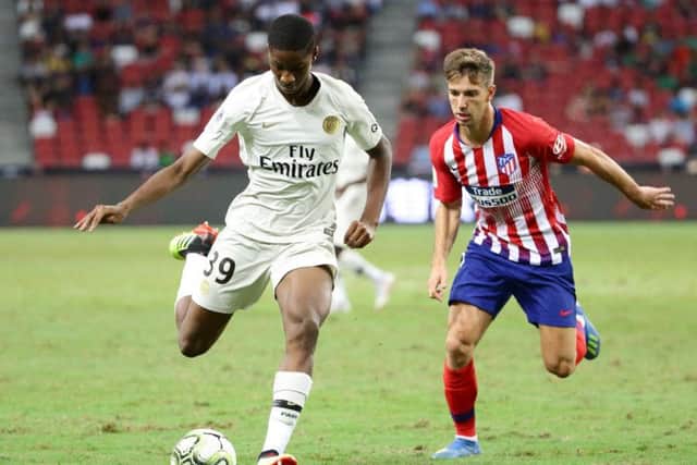 Moussa Sissako shields the ball from Atletico Madrid's Luciano Vietto