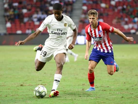 Moussa Sissako shields the ball from Atletico Madrid's Luciano Vietto