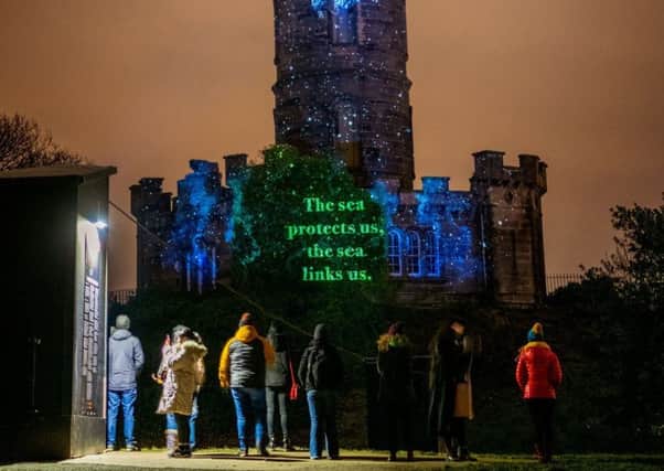 Robin Robertson's text for Message From The Skies is projected onto the Nelson Monument on Calton Hill