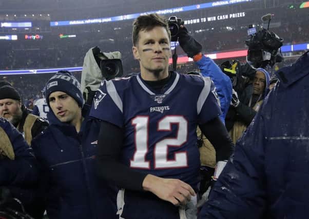 Tom Brady walks off the Foxborough pitch, possibly for the last time, following Patriots 20-13 defeat. Picture: Charles Krupa/AP