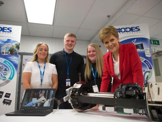 Diodes employees Caitlin Kirk, Ross MacDonald and Aimee Cooke with First Minister Nicola Sturgeon. Picture: Contributed