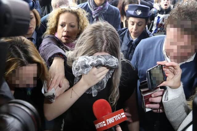 A 19 year-old British woman, centre, who was found guilty of making up claims she was raped by up to 12 Israelis arrives at Famagusta District Court. Picture: PA