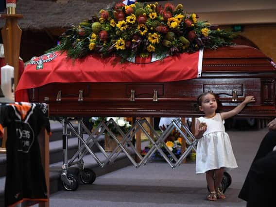 Charlotte O'Dwyer, the youngest daughter of Rural Fire Service volunteer Andrew O'Dwyer stands in front of her father's casket. Picture: GettyImages