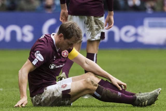 Christophe Berra cuts a forlorn figure after Hearts' defeat by Hibs on Boxing Day.