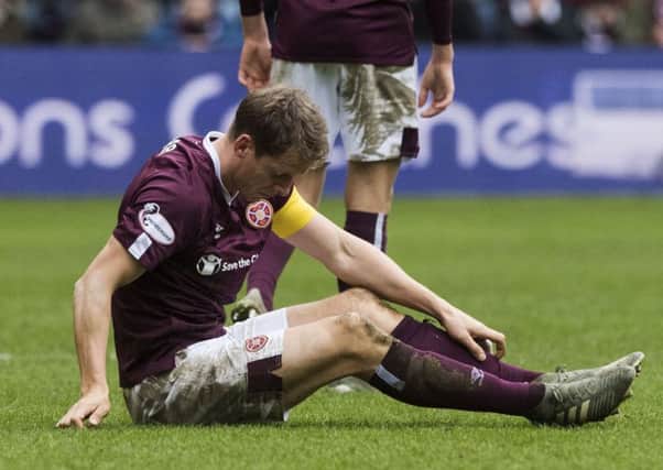 Christophe Berra cuts a forlorn figure after Hearts' defeat by Hibs on Boxing Day.