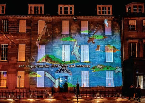 Charlotte Runcie's Message From The Skies text projected onto the Northern Lighthouse Board building on George Street
