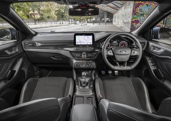 The Ford Focus ST cockpit features Recaro front seats.