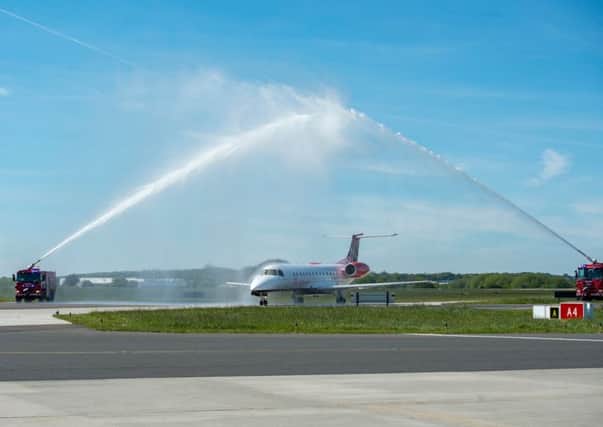 A plane arriving at London Southend Airport is met by a water-arch salute (Picture: Simon Ford/Shutterstock)