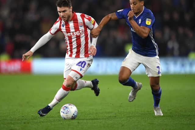Scott Hogan in action for Stoke against Cardiff's Lee Peltier